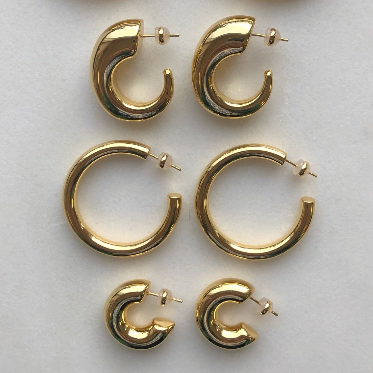 high polished 18K gold plated brass statement chunky large hoops in that are light and hollow – minimalist trendy jewelry made in Vermont, perfect for casual wear, date night, work, weddings, gifting, or everyday wear.