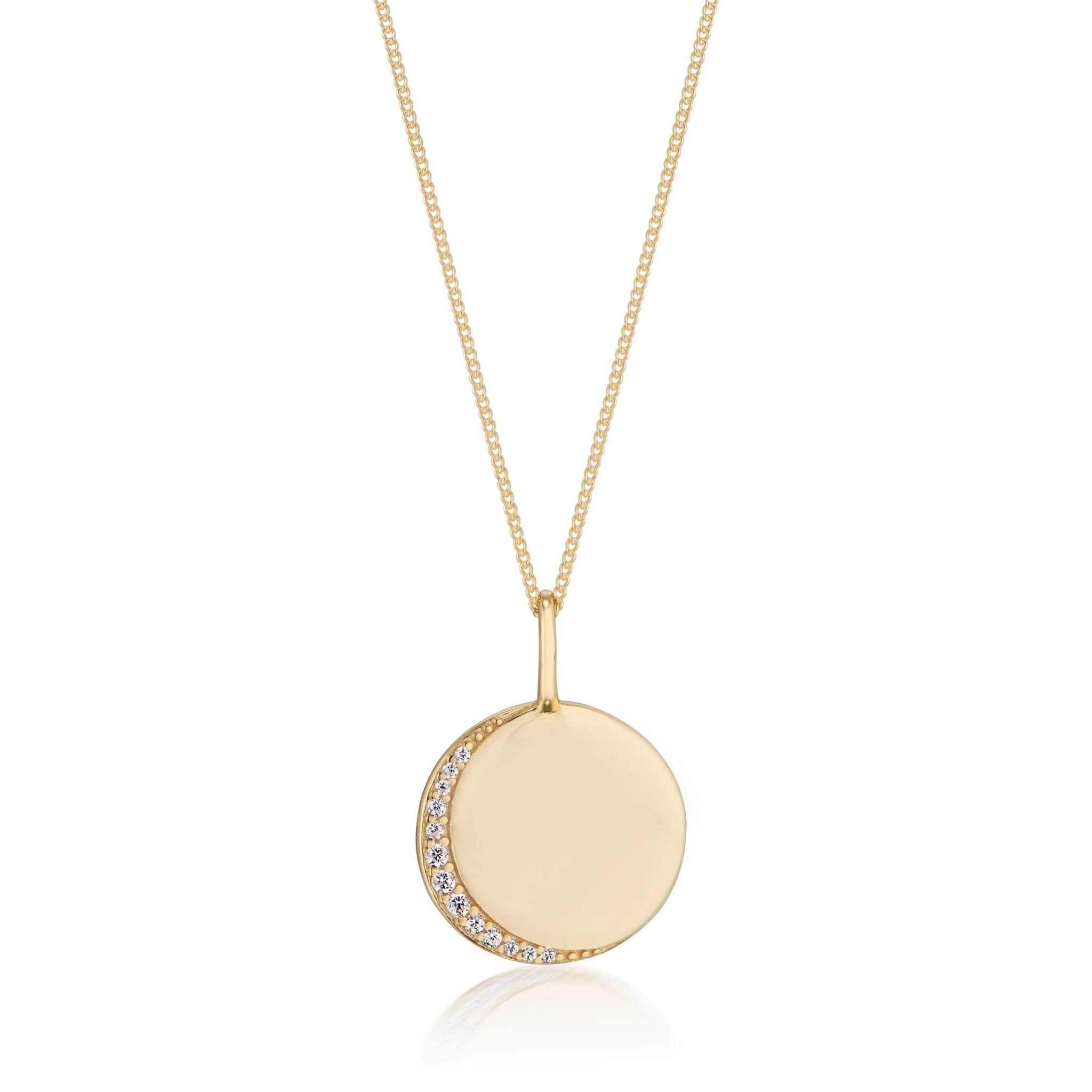 Alice Gold Disc Pendant Necklace from Elli Parr — a sleek round gold pendant accented with a crescent of pavé-set white stones, hanging from a delicate gold chain for a timeless, elegant look.