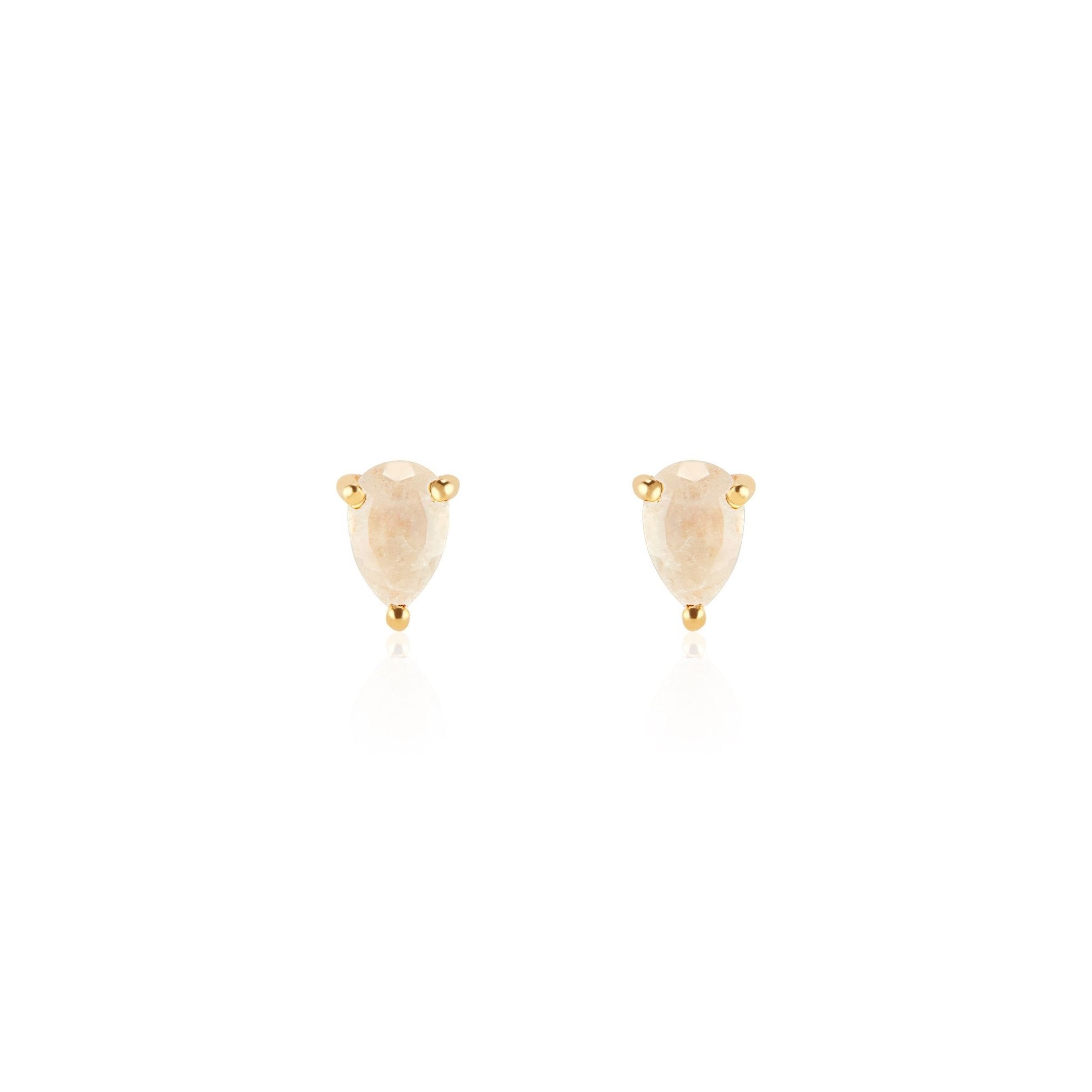 Close-up of elegant rainbow moonstone teardrop stud earrings set in 14K gold vermeil displayed on a neutral-toned fabric background. The polished moonstone gemstones are cut in a teardrop faceted shape, reflecting light for a subtle shine—handcrafted minimalist jewelry made in Vermont from Elli Parr.